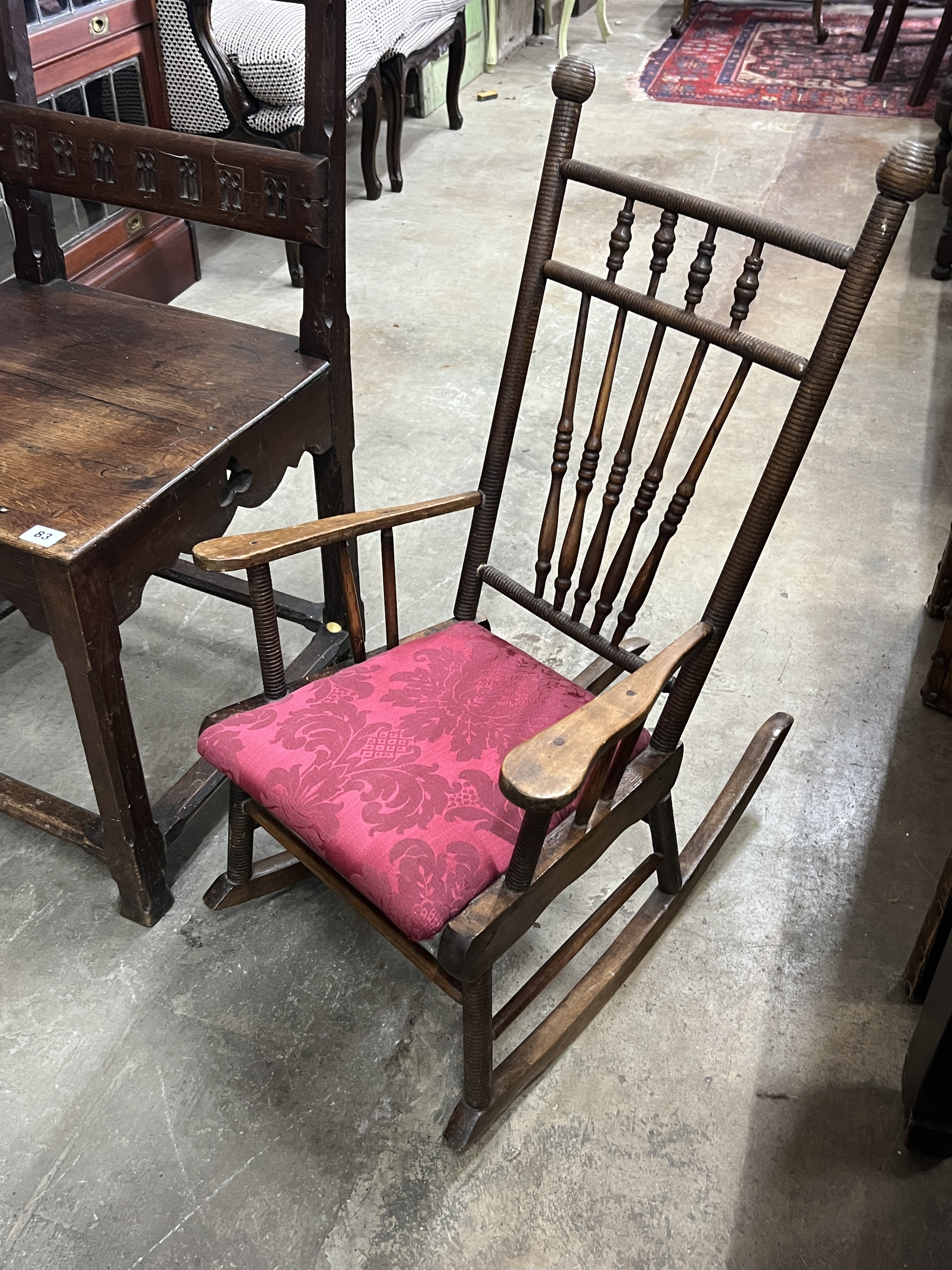 A Victorian carved oak high-back chair, width 49cm, height 118cm together with an early 20th century child's rocking chair